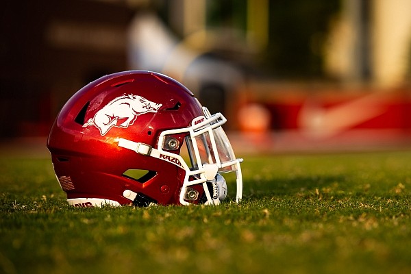 An Arkansas Razorbacks football helmet sits on the field during a preseason practice on Sept. 15, 2020 in Fayetteville.