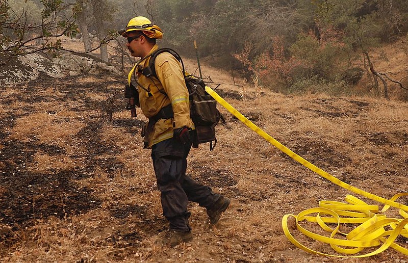 Firefighter Skip Irland of Hemet, Calif., moves in on a wildfire hot spot Thursday in California’s Sequoia National Forest. While progress has been made in the recent round of fires, the effort has taxed personnel and resources in a fire season that has barely begun.
(The New York Times/Daniel Dreifuss)
