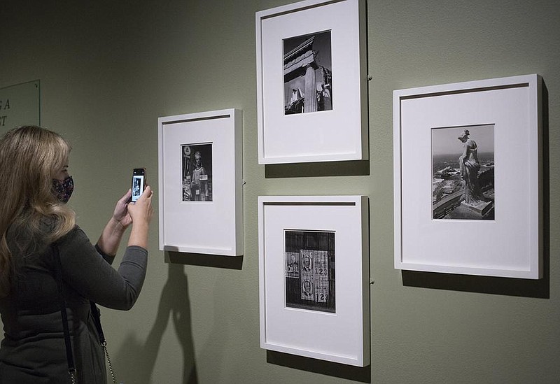 Jerra Nallie of Cave Springs looks Tuesday at Great Depression era images produced by Ansel Adams at Crystal Bridges in Bentonville. The Ansel Adams temporary exhibition opens Saturday.
(NWA Democrat-Gazette/Charlie Kaijo)