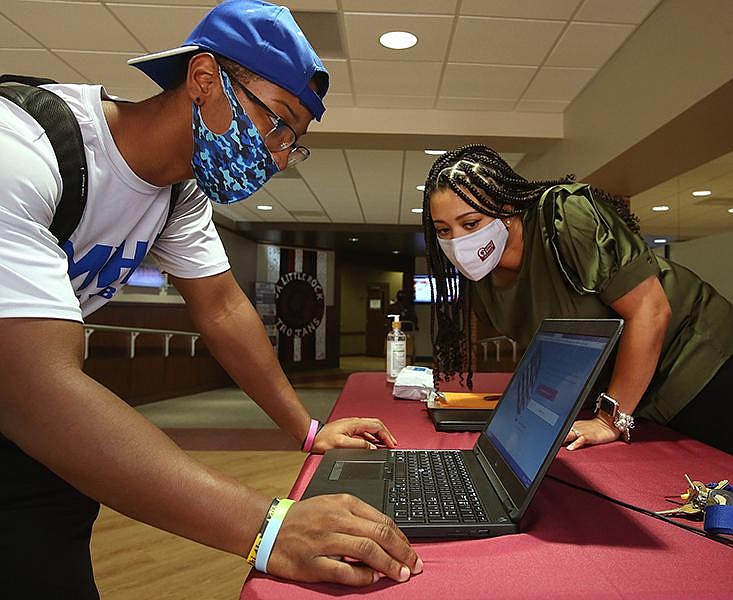 Kevin Davidson of Monticello gets help from Mia Phillips, assistant vice chancellor for student affairs, during a voter registration drive at University of Arkansas at Little Rock's Donaghey Student Center on Thursday, Sept. 17, 2020, for Constitution Day. UALR will hold another voter registration event as part of National Voter Registration Day on Tuesday in the library courtyard. 
(Arkansas Democrat-Gazette/Thomas Metthe)