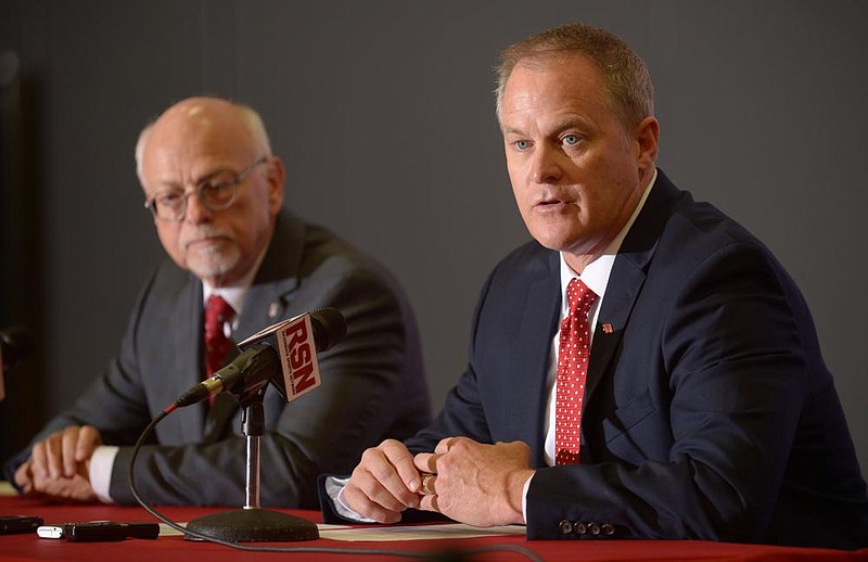 In this file photo Hunter Yurachek (right) speaks Wednesday, Dec. 6, 2017, alongside Joe Steinmetz, chancellor of the University of Arkansas, during a news conference in the Fowler Family Baseball and Track Indoor Training Center in Fayetteville.
(NWA Democrat-Gazette/ANDY SHUPE)