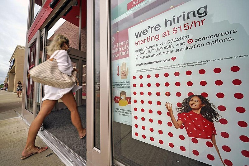 A help-wanted sign hangs on the door of a Target store in Uniontown, Pa., earlier this month. The economy and job market have recovered somewhat from the initial shock of the pandemic.
(AP)