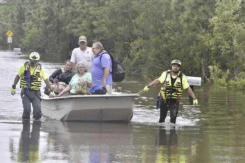 Members of an Indiana citizen response team assist in a high-water rescue of residents Thursday in Pensacola, Fla. More photos at arkansasonline.com/918sally/.
(AP/Pensacola News Journal/Tony Giberson)