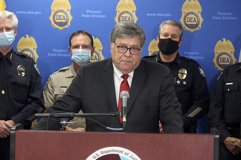 U.S. Attorney General William Barr speaks at a news conference, Thursday, Sept. 10, 2020, in Phoenix, where he announced results of a crackdown on international drug trafficking. Barr spent much of his time attacking mail-in voting, defending a Justice Department decision to take over defense of President Trump in a defamation case and discussing the civil unrest triggered by the killing of George Floyd by Minneapolis police in May. 
(AP Photo/Bob Christie)