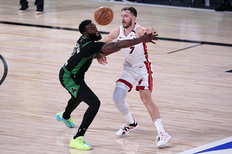 Boston Celtics guard Jaylen Brown (left) defends Miami Heat guard Goran Dragic during the second half of Game 2 of the NBA Eastern Conference final Thursday in Lake Buena Vista, Fla. Dragic scored nine points in the fourth quarter to help the Heat rally to a 106-101 victory for a 2-0 series lead.
(AP/Mark J. Terrill)