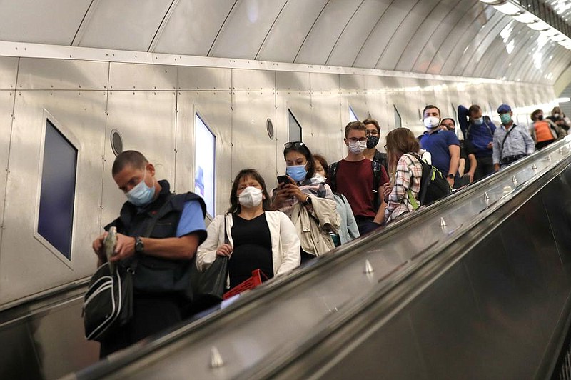 People take the escalator Thursday in the subway in Prague, Czech Republic. As cases soar in a second wave of the coronavirus, officials have further tightened already restrictive measures.
(AP/Petr David Josek)