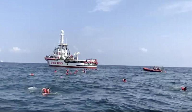 Migrants wearing life jackets swim toward shore Thursday off the coast of Palermo, Italy, in this image taken from video.
(AP/Open Arms)