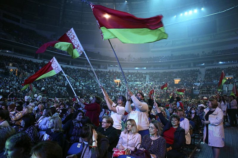 Women wave Belarusian flags Thursday in Minsk, as they listen to President Alexander Lukashenko during a women’s forum. More photos at arkansasonline.com/918belarus/.
(AP/TUT.by)