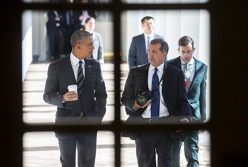 President Barack Obama walks and talks with photographer Pete Souza in a scene from the documentary “The Way I See It,” which is largely about Souza’s time as official White House photographer.