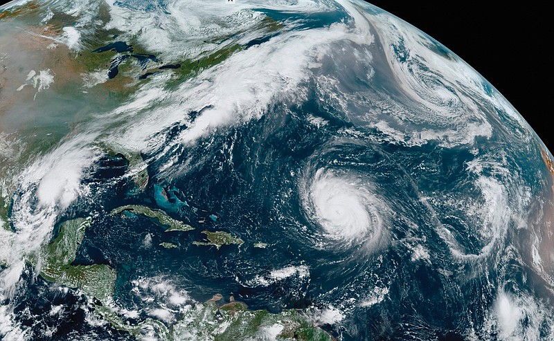 This satellite image from Friday of the Atlantic shows Hurricane Teddy, now Alpha (center), Tropical Depression 22 (left) in the Gulf of Mexico, the remnants of Hurricane Paulette (top right) and Tropical Storm Wilfred (lower right). More photos at arkansasonline.com/919sally/.
(AP/NOAA)