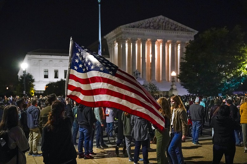 People gather at the Supreme Court in Washington on Saturday night, Sept. 19, 2020, to honor the late Justice Ruth Bader Ginsburg. President Donald Trump has urged the Republican-run Senate to consider “without delay” his coming nomination to fill the vacancy left on the high court by Ginsburg's death.