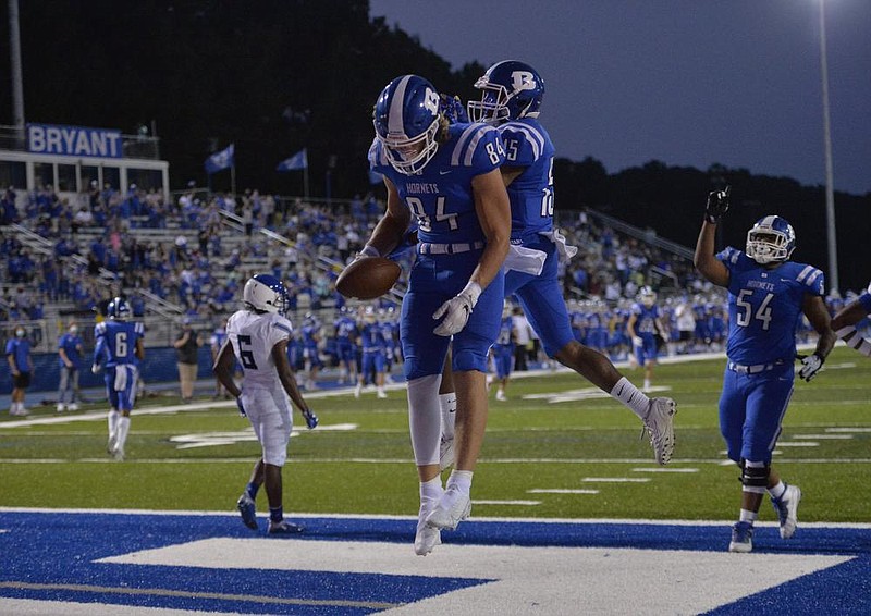 Bryant tight end Hayden Schrader (84) celebrates with receiver Jordan Knox (15) after scoring against Trinity Christian on Friday at Hornet Stadium in Bryant. The Hornets rallied to win 44-40 to extend their winning streak to 20 games. More photos at arkansasonline.com/919trinity/
(Special to the Democrat-Gazette/Jimmy Jones)