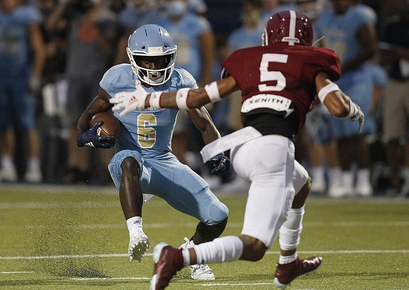 Pulaski Academy running back Joe Himon (6) makes a cut to avoid Life Christian Academy defensive back Antonio Cotman (5) during the second quarter of the Bruins’ 31-20 victory Friday at Hatcher Field in Little Rock. More photos at arkansasonline.com/919lifepa/.
(Arkansas Democrat-Gazette/Thomas Metthe)