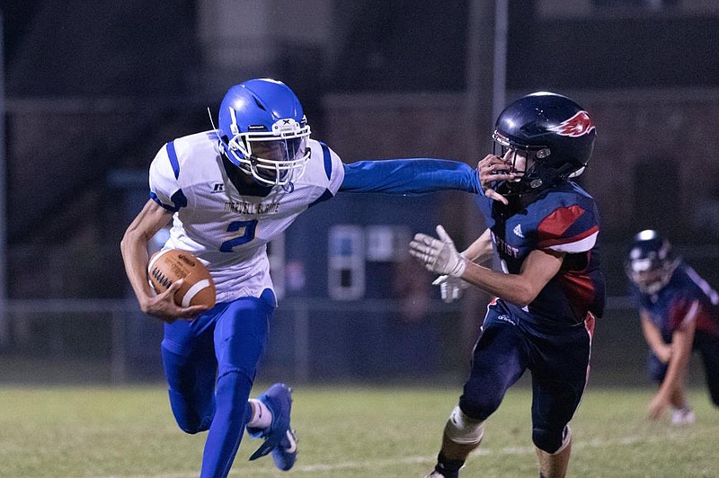 Marvell quarterback Deandra Arnold (left) stiff-arms Baptist Prep free safety Blake Brown in Marvell’s 24-20 victory on Friday night at Baptist Prep in Little Rock. More photos available online at arkansasonline.com/919marvell.
(Arkansas Democrat-Gazette/Justin Cunningham)