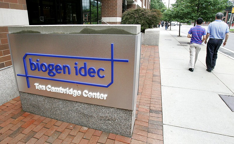 Pedestrians pass Biogen Idec Inc. headquarters in Cambridge, Mass., in this July 23, 2007, file photo. Biogen is the maker of Rituxan, a drug that Colorado farmer Michael Costanzo takes intravenously every six months to help manage his multiple sclerosis.