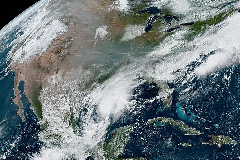 This satellite image taken Friday by the National Oceanic and Atmospheric Administration shows smoke from Western wildfires drifting across the continent, remnants of Hurricane Sally in the Southeast and dry air in between. 
(AP/NOAA) 