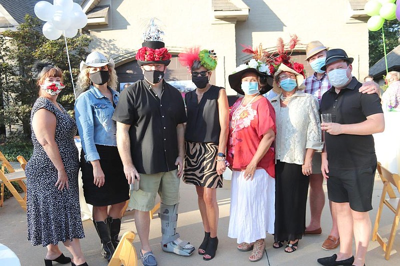 Jamie Griffith, Amanda and Wallace Smith, Suzanne Catlett, Deborah Jackson, Lucy Cyphers of Camden, and Grant Laisure and Clay Sutton, both of Alexander, display their festive head gear at a watch party for Southern Silks, a Kentucky Derby-related fundraiser for Methodist Family Health. The party took place Sept. 5 at the west Little Rock home of Amanda and Wallace Smith.
(Arkansas Democrat-Gazette -- Helaine R. Williams)