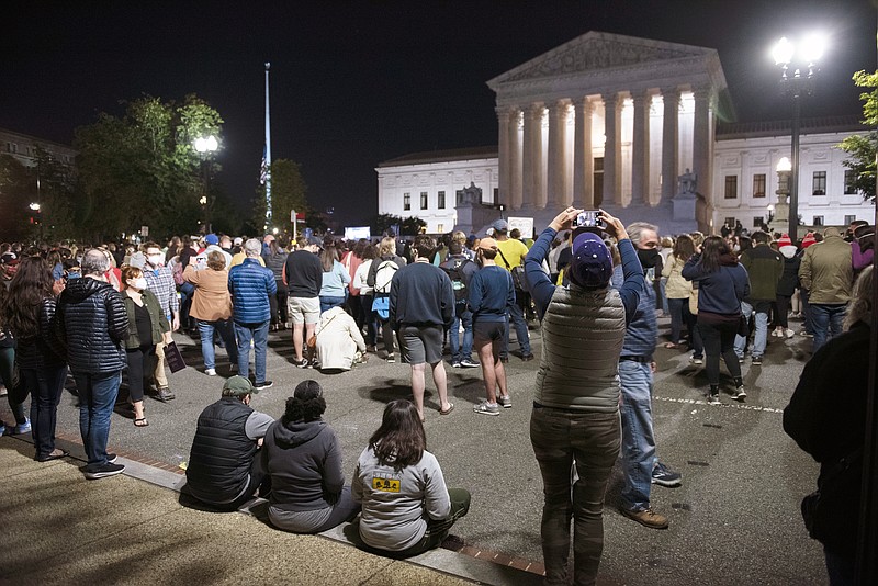 People gather at the Supreme Court to honor the late Justice Ruth Bader Ginsburg, Saturday, Sept. 19, 2020, in Washington. (AP Photo/Cliff Owen)