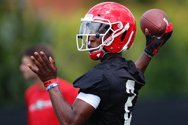 Georgia quarterback D'Wan Mathis throw a pass during the team's first scheduled NCAA college football practice Friday, Aug. 2, 2019, in Athens, Ga. (AP Photo/John Bazemore)