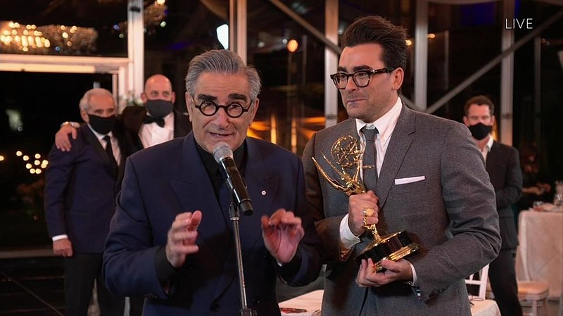 Eugene Levy, left, and Daniel Levy from "Schitt's Creek" accept the Emmy for Outstanding Comedy Series during the 72nd Emmy Awards telecast on Sunday, Sept. 20, 2020 at 8:00 PM EDT/5:00 PM PDT on ABC. (Invision for the Television Academy/AP)