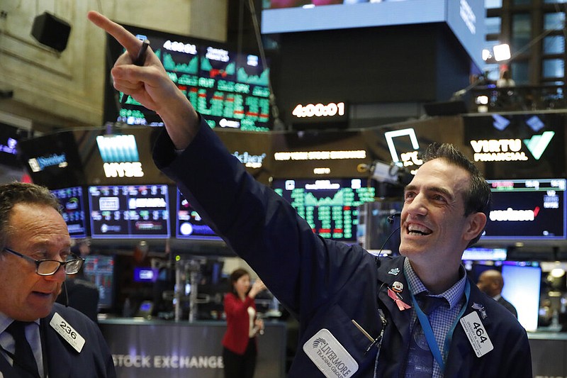 FILE - In this March 10, 2020, file photo, traders Steven Kaplan, left, and Gregory Rowe react at the closing on the floor of the New York Stock Exchange.