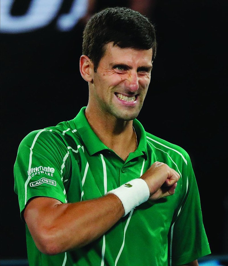 Serbia's Novak Djokovic celebrates after defeating Austria's Dominic Thiem in the final of the Australian Open tennis championship in Melbourne, Australia, Sunday, Feb. 2, 2020. (AP Photo/Lee Jin-man)