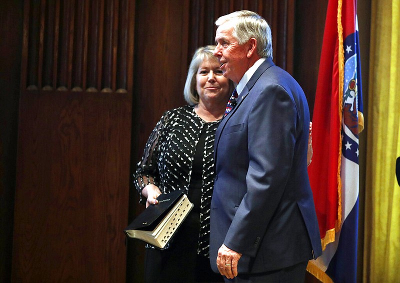 FILE - In this June 1, 2018 file photo, Gov. Mike Parson, right, smiles along side his wife, Teresa, after being sworn in as Missouri's 57th governor in Jefferson City, Mo. Teresa Parson has tested positive for the coronavirus after experiencing mild symptoms, a spokeswoman for the governor said Wednesday, Sept. 23, 2020. (AP Photo/Jeff Roberson, File)

