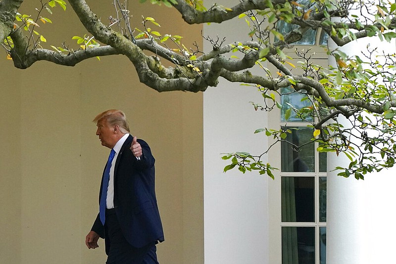 President Donald Trump gestures to members of the press as he walks to the Oval Office of the White House after visiting the Supreme Court to pay respects to Justice Ruth Bader Ginsburg, Thursday, Sept. 24, 2020, in Washington. (AP Photo/Patrick Semansky)

