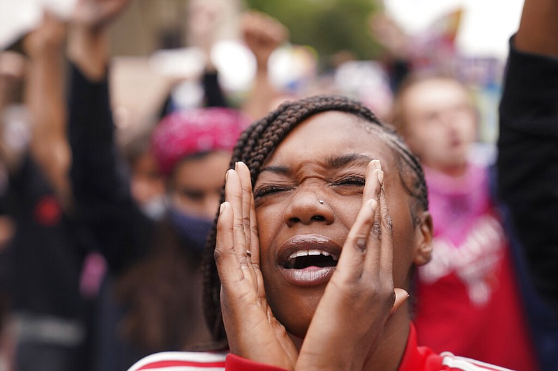 A woman speaks during a protest, Wednesday, Sept. 23, 2020, in Louisville, Ky.