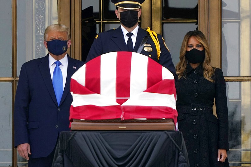 President Donald Trump and first lady Melania Trump pay respects as Justice Ruth Bader Ginsburg lies in repose at the Supreme Court building on Thursday, Sept. 24, 2020, in Washington.