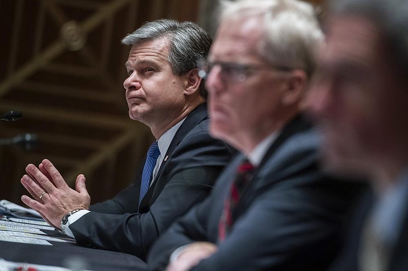 FBI Director Christopher Wray (left) on Thursday attends a Senate Homeland Security Committee hearing, where he told lawmakers, “We are not going to tolerate foreign interference in our elections.”
(AP/Tom Williams)