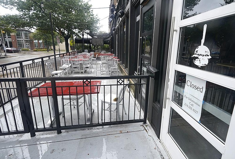 The patio of a closed burger restaurant sits empty Sept. 2 in Dallas. The number of people seeking unemployment aid ticked up last week.
(AP)