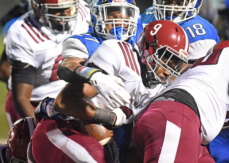 Sylvan Hills’ Xavier Okafor (left) tackles Pine Bluff’s Zaevion Barnett during the first half Thursday at Bill Blackwood Field in Sherwood. More photos available at arkansasonline.com/925pbsylvan/.
(Arkansas Democrat-Gazette/Staci Vandagriff)