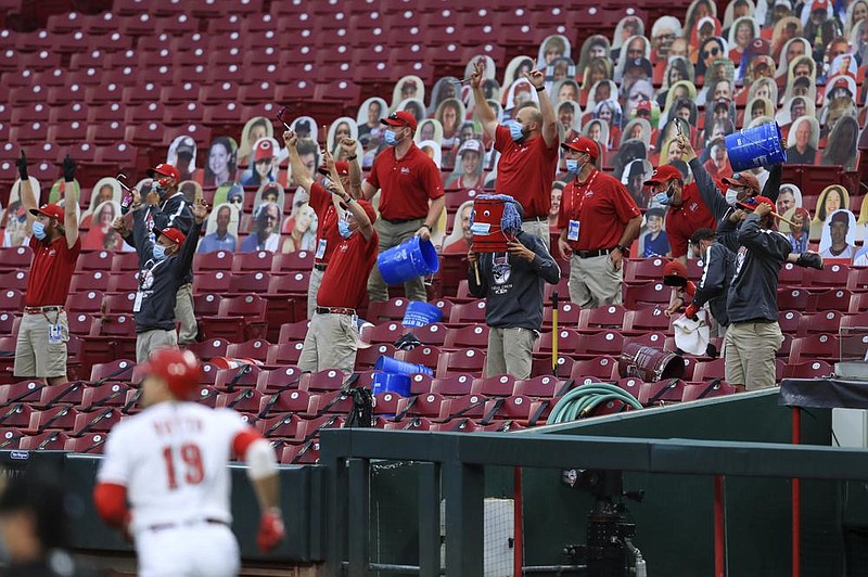 Members of the Cincinnati Reds’ grounds crew react as Joey Votto runs the bases after hitting a two-run home run during Wednesday’s game against the Milwaukee Brewers in Cincinnati.
(AP/Aaron Doster)