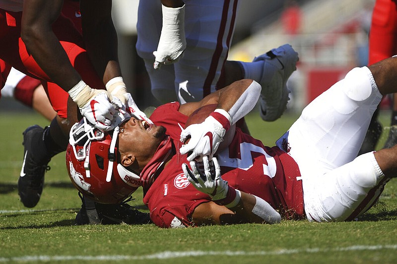 Arkansas running back Rakeem Boyd (5) gets his helmet ripped off by Georgia defender Monty Rice during the first half of an NCAA college football game in Fayetteville on Saturday, Sept. 26, 2020.