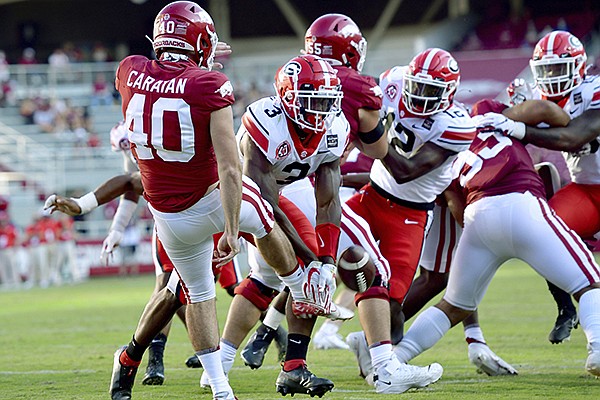 Georgia's Zamir White (3) blocks a punt by Arkansas' George Caratan (40) during the second half of game Saturday, Sept. 26, 2020, in Fayetteville. (AP Photo/Michael Woods)


