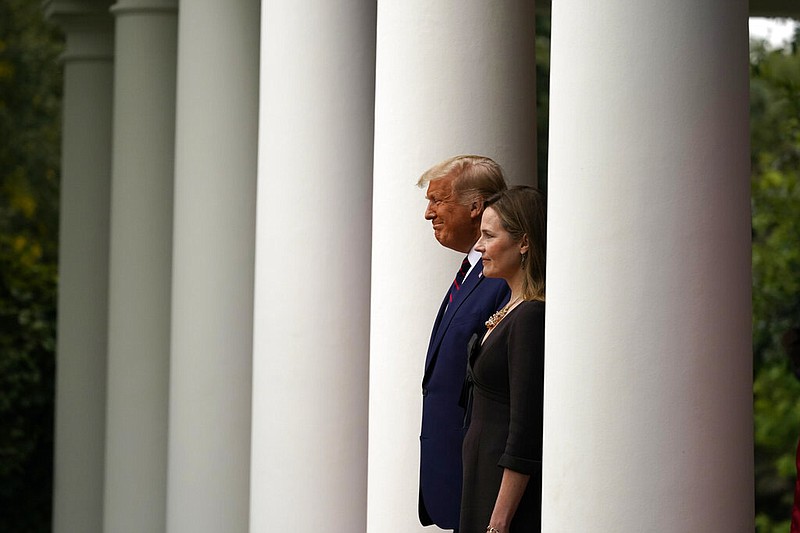 President Donald Trump walks with Judge Amy Coney Barrett to a news conference to announce Barrett as his nominee to the Supreme Court, in the Rose Garden at the White House, Saturday, Sept. 26, 2020, in Washington.