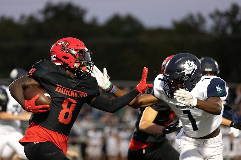 Maumelle wide receiver Dashaire Ford-Burton (left) attempts to stiff-arm Little Rock Christian’s Landon Nelson during Friday night’s game in Maumelle. More photos available at at arkansasonline.com/926maumelle.
(Arkansas Democrat-Gazette/Justin Cunningham)