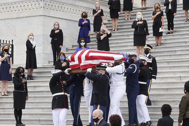 Members of Congress, including many women, look on as the flag-draped casket of Justice Ruth Bader Ginsburg is carried out by a joint services military honor guard Friday after lying in state at the U.S. Capitol. More photos at arkansasonline.com/926rbg/.
(AP/Jonathan Ernst)
