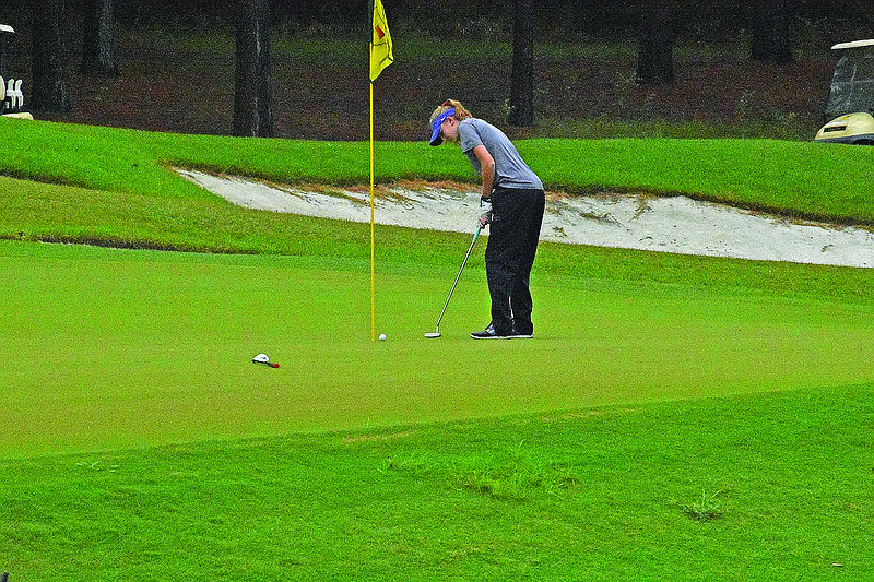 El Dorado's Hope Walthall hits a putt while competing in the conference golf tournament last week at Mystic Creek. The Lady Wildcats will play for the 5A State championship today in Mountain Home.