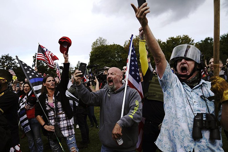 Members of the Proud Boys and other right-wing demonstrators rally Saturday in Portland, Ore. More photos at arkansasonline.com/927portland/. (AP/John Locher) 