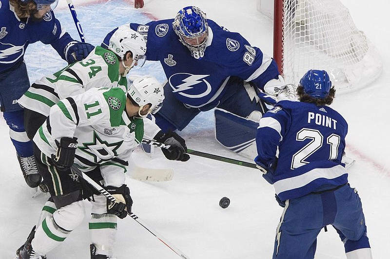 Tampa Bay Lightning goaltender Andrei Vasilevskiy (88) stops Dallas Stars right wing Denis Gurianov (34) as Lightning center Brayden Point (21) and Stars center Andrew Cogliano (11) look for a rebound during the rst period of the Stanley Cup Final. Dallas won 3-2 in double overtime to force game six on Monday night. 
(AP/The Canadian Press/Jason Franson) 