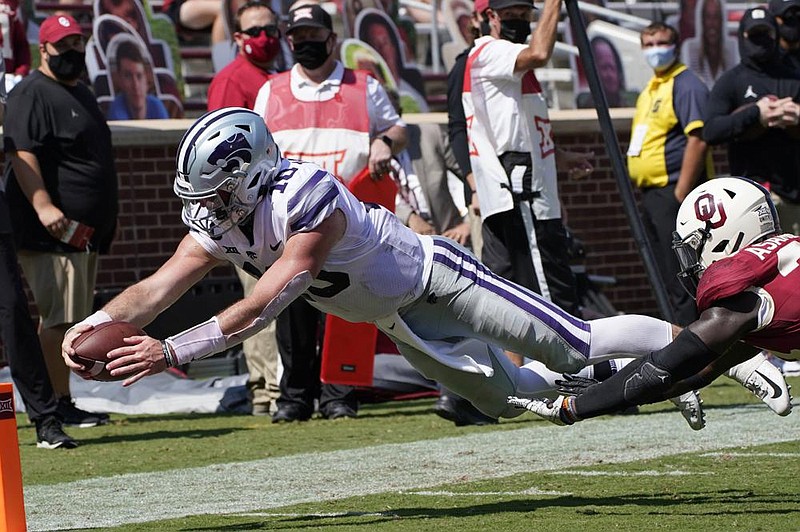 Kansas State quarterback Skylar Thompson (10) dives into the end zone for a touchdown Saturday in front of Oklahoma linebacker Brian Asamoah during the second half of the Wildcats’ 38-35 victory over the No. 3 Sooners in Norman, Okla. (AP/Sue Ogrocki) 