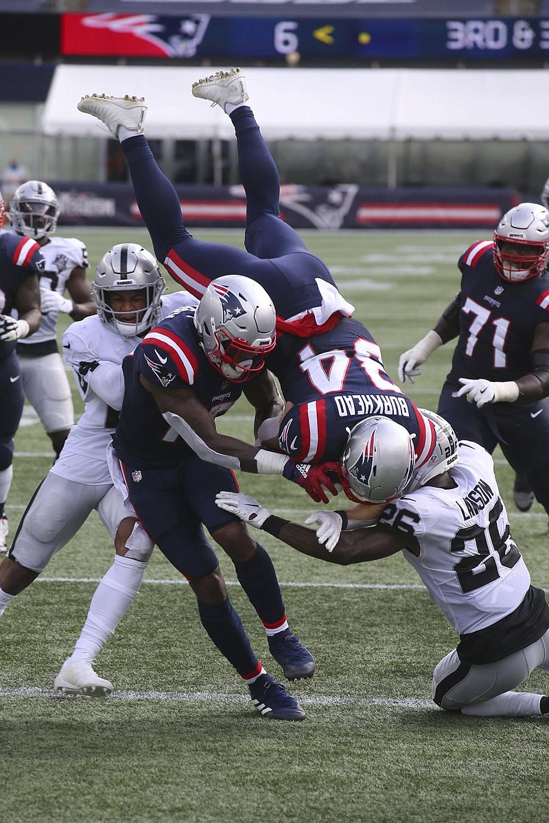 New England Patriots running back Rex Burkhead (34) scores as Las Vegas Raiders defensive back Nevin Lawson (26) defends during the second half Sunday in Foxborough, Mass. Burkhead had two rushing touchdowns and 1 receiving score to help the Patriots win 36-20. 
(AP/Stew Milne)