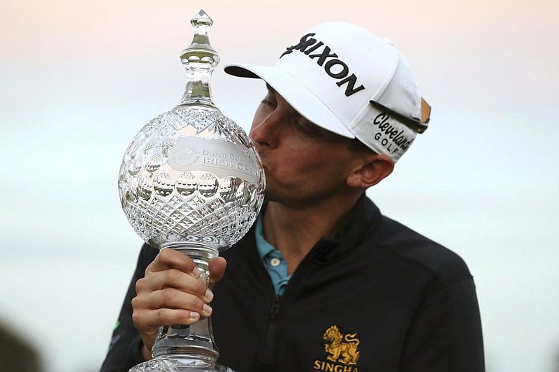 John Catlin celebrates with the trophy after winning The Irish Open at Galgorm Castle Golf Club, in Ballymena, Northern Ireland, on Sunday. (AP/Brian Lawless) 