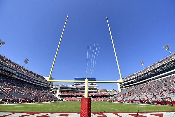 A flight team flies over Donald W. Reynolds Razorback Stadium prior to a game between Arkansas and Georgia on Saturday, Sept. 26, 2020, in Fayetteville. (AP Photo/Michael Woods)