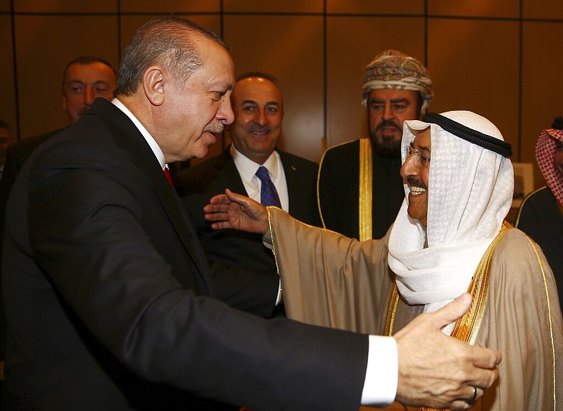 FILE - In this Wednesday, Dec. 13, 2017 file photo, Turkey's President Recep Tayyip Erdogan, left, welcomes Kuwait's Emir Sheikh Sabah Al Ahmad Al Sabah, prior to the opening session of the Organisation of Islamic Cooperation Extraordinary Summit in Istanbul.