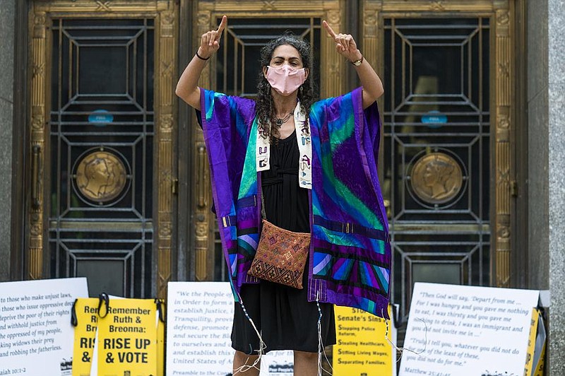 Rabbi Daria Jacobs-Velde says prayers Tuesday in front of the Dirk- sen Senate office building in Washington in remembrance of Jus- tice Ruth Bader Ginsburg and Breonna Taylor. (AP/Manuel Balce Ceneta) 