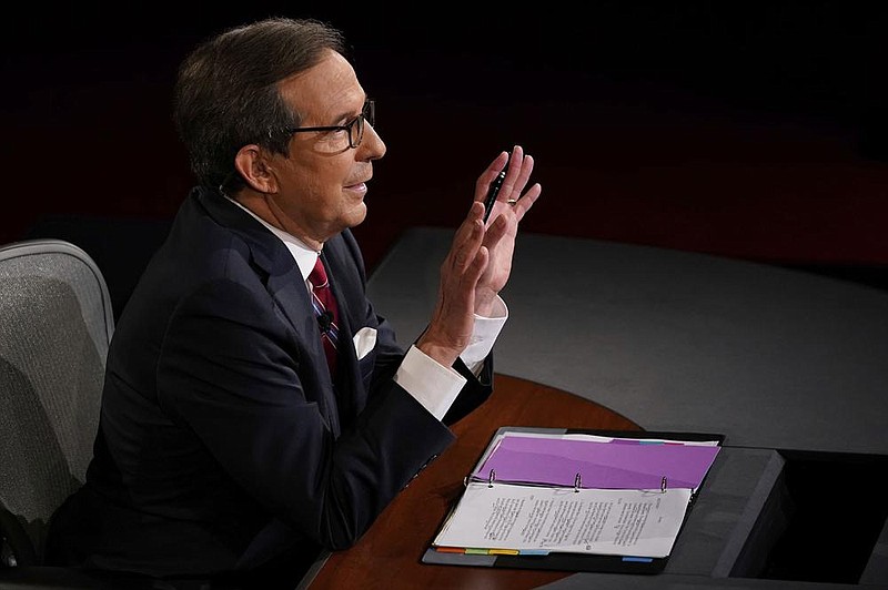 Moderator Chris Wallace of Fox News gestures toward President Donald Trump and Democratic presidential candidate former Vice President Joe Biden during the first presidential debate Tuesday, Sept. 29, 2020, at Case Western University and Cleveland Clinic, in Cleveland, Ohio. (AP Photo/Morry Gash, Pool)