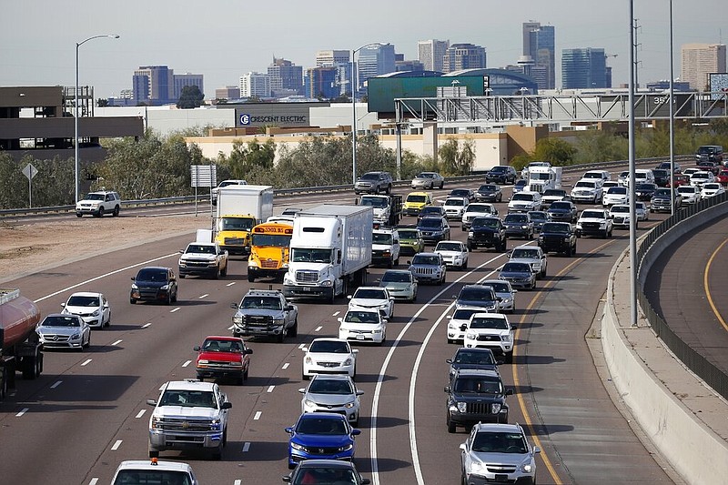 FILE - In this Jan. 24, 2020 file photo, early rush hour traffic rolls along I-10 in Phoenix. Traffic deaths in the U.S. fell for the third straight year in 2019, the government's road safety agency said Thursday, Oct. 1. The National Highway Traffic Safety Administration says the downward trend is continuing into this year with people driving fewer miles due to the pandemic. (AP Photo/Ross D. Franklin, File)

